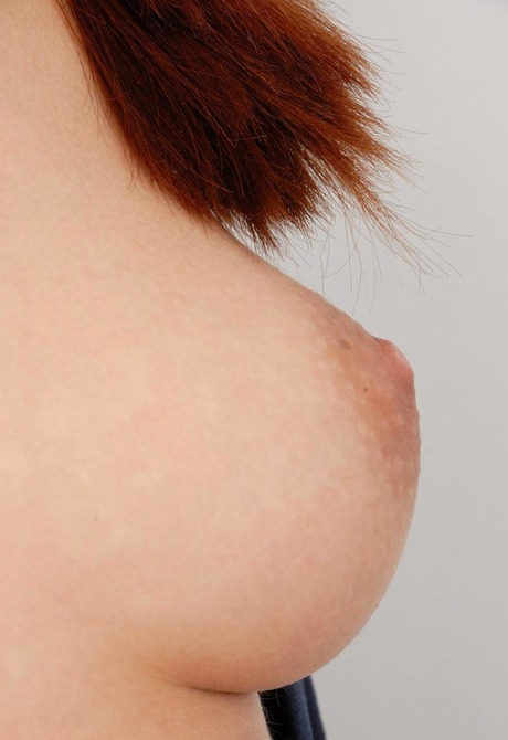 Nerdy redheaded babe Getty stripteases in sexy high heels - 12 of 15