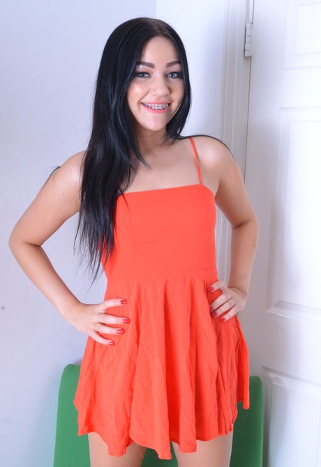 Tempting teen Karly strips off her dress and poses naughty