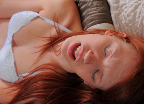 Redhead babe Pepper pleasures her pussy with a clear dildo