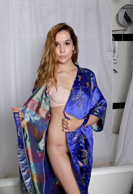 Perky teen Kasey showing tan lines and pissing in bathtub - 2 of 16