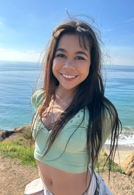 Babe teases with her tits on the beach in sexy black knee socks and heels while smoking - 6 of 12