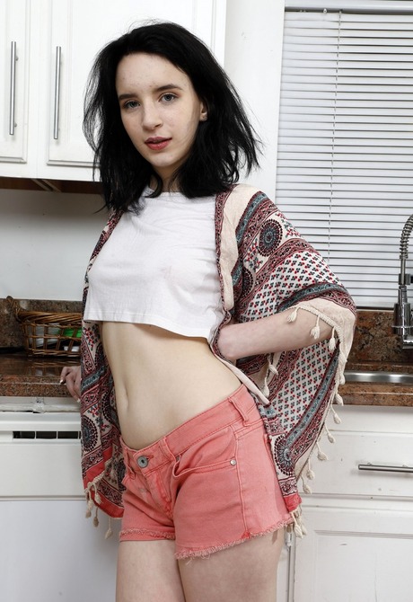 Skinny teen Lily Moon peeling off shorts in kitchen