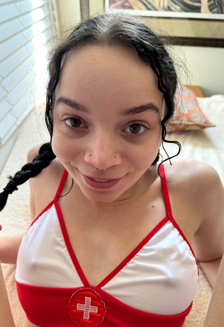 Cute teen Selina Imai in nurse top and white stockings teases with shaved pussy and feet - 11 of 16