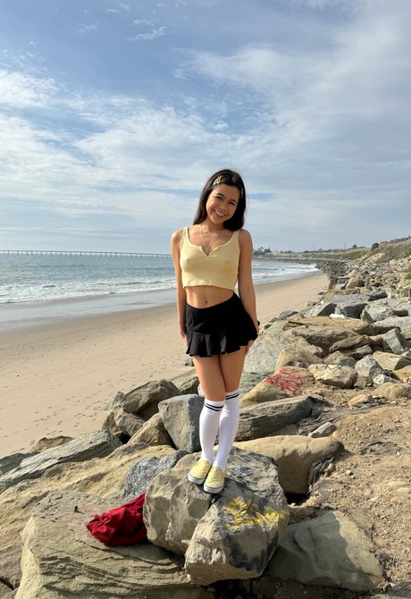 Cute Asian Brianna Arson wears knee socks outdoors in public and flashes pussy at beach