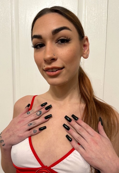 Tattooed brunette Delilah Day in nurse outfit and white stockings teases in sexy positions - 2 of 16