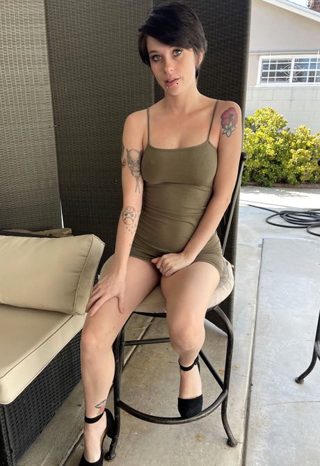 Kitty Lynn seductively gets naked on the couch and spreads pussy