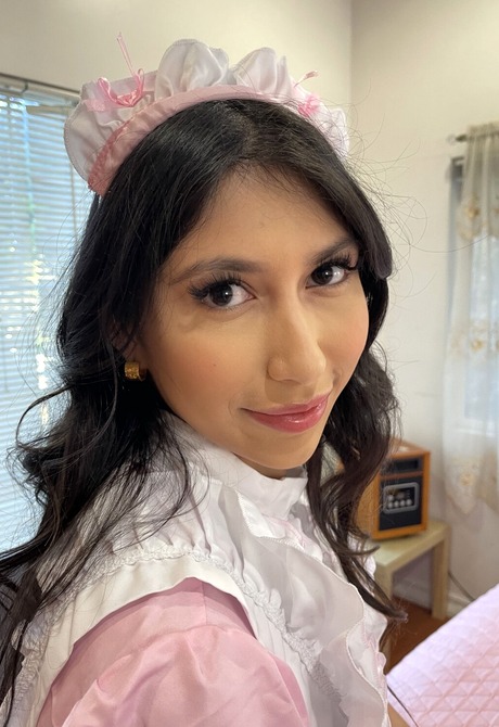 Latina babe Penelope Woods stripping off maid uniform in bedroom