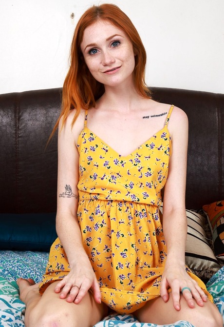 Naughty redhead teen Scarlet Skies spreading shaved pussy on bed