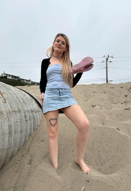 Blonde with glasses Riley Rose shows hairy pussy outdoors before indoor teasing